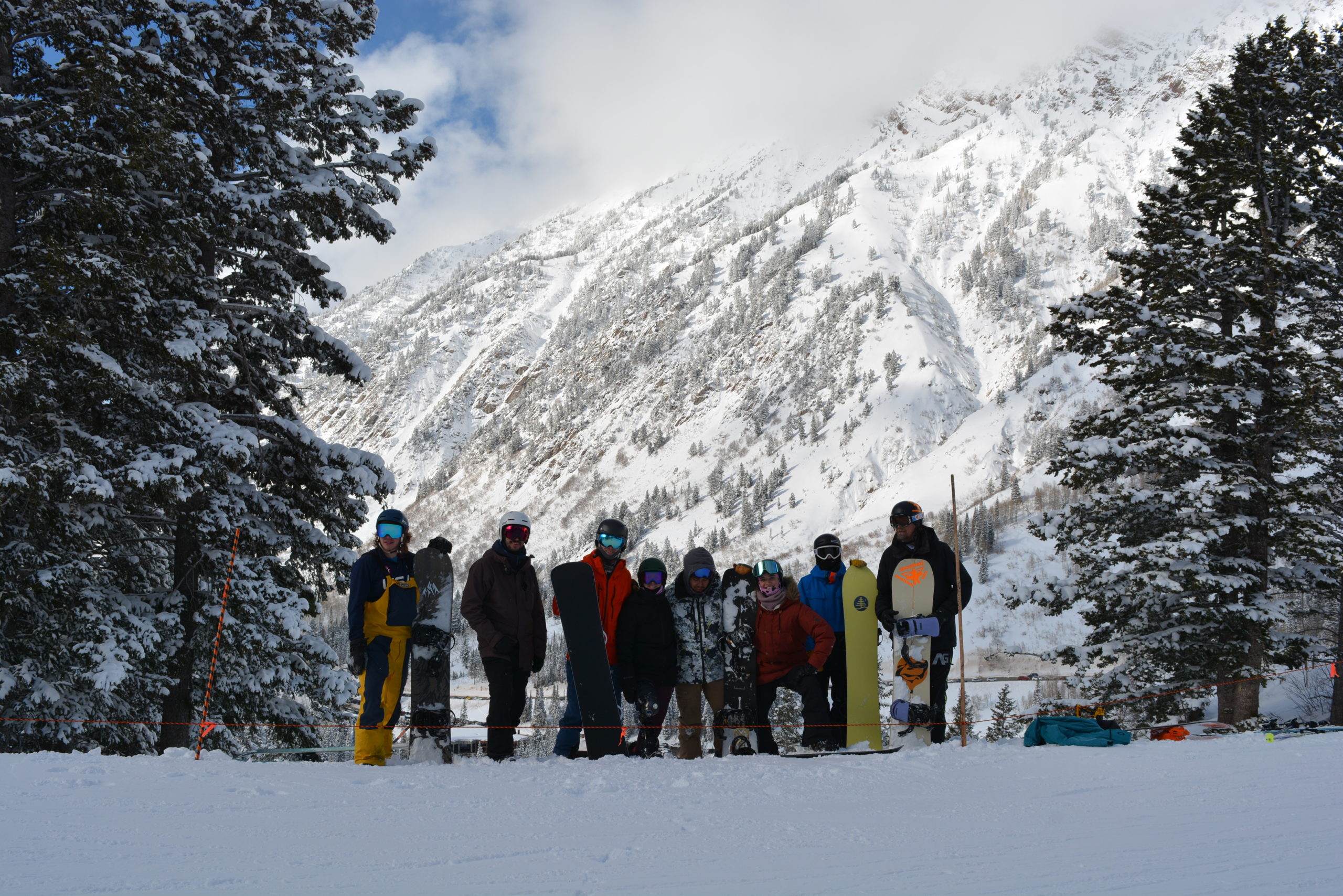 Group of snowboarders on snowy mountain slope
