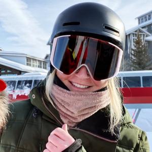 Smiling skier wearing helmet and goggles