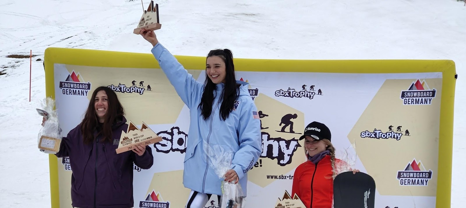 Three snowboarders on winners' podium