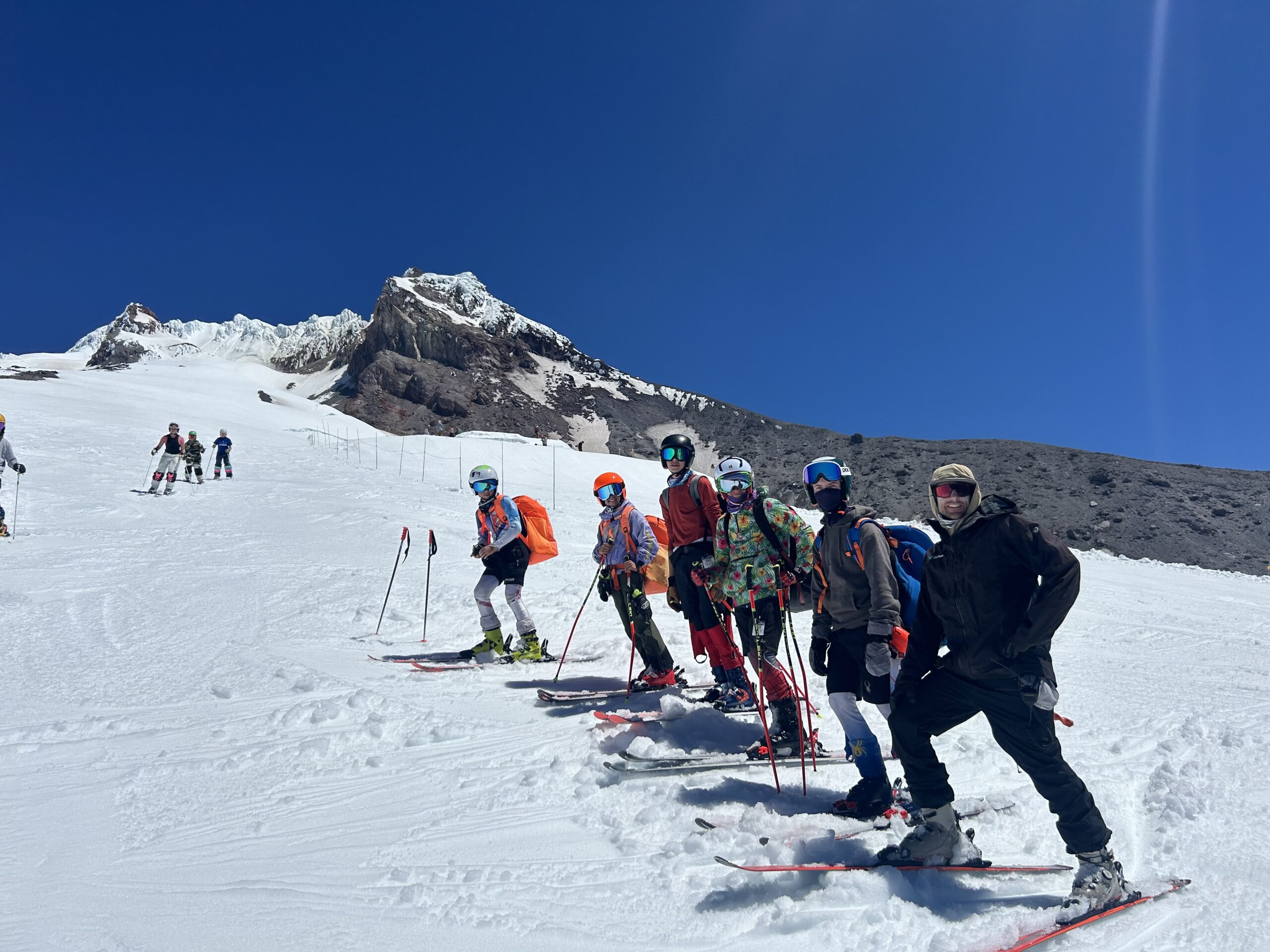 Group of skiers on snowy mountain slope