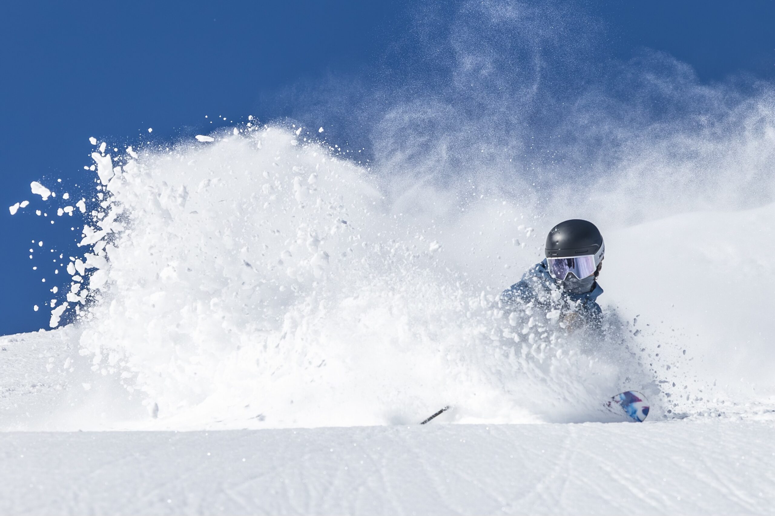 Skier carving through deep powder snow