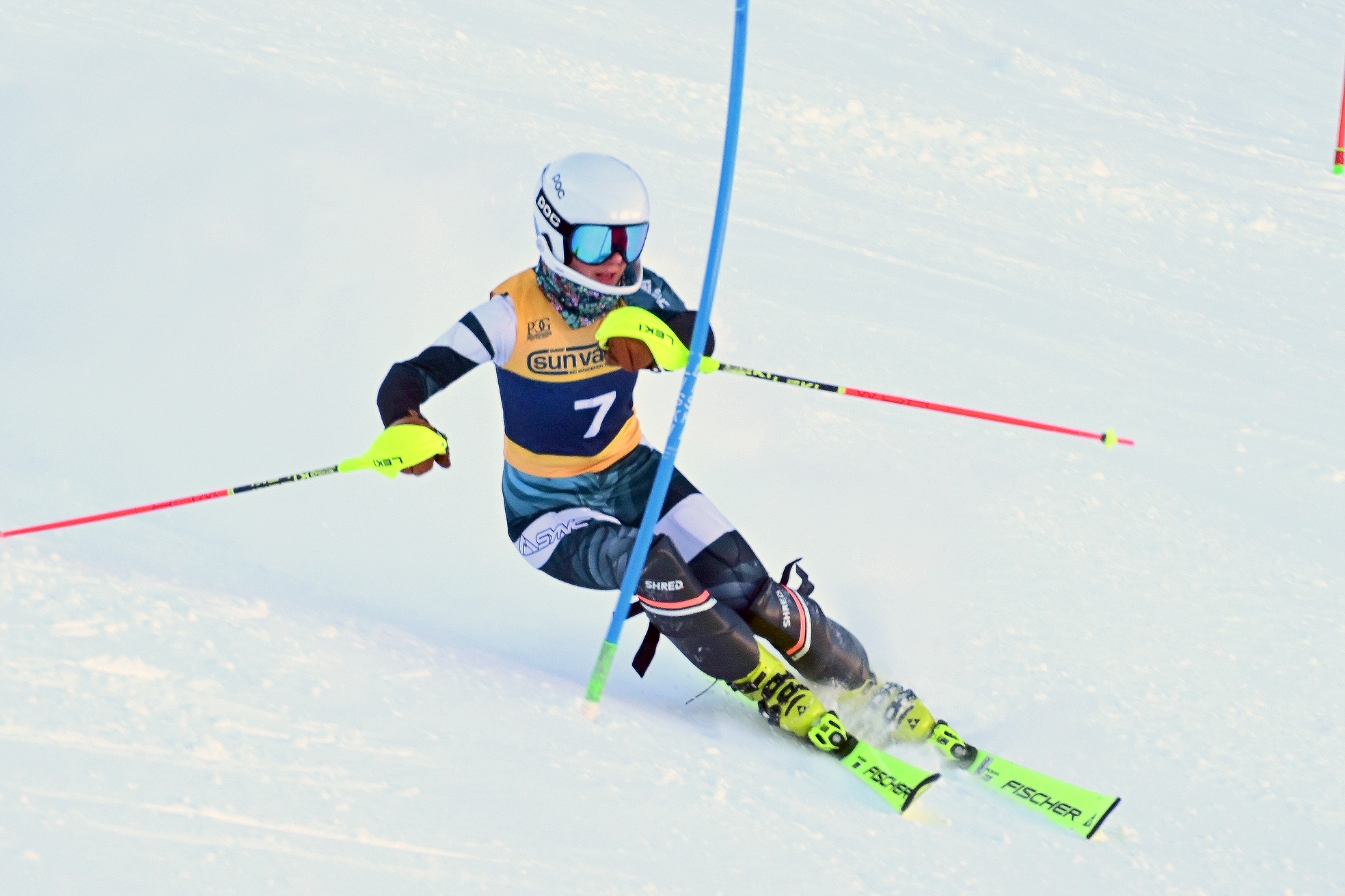 Skier racing slalom through gate