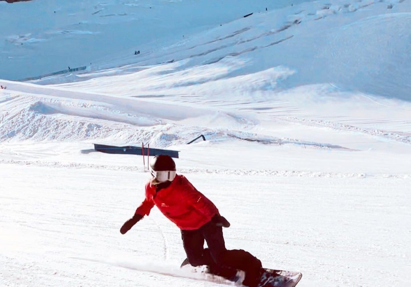 Snowboarder carving on snowy mountain slope