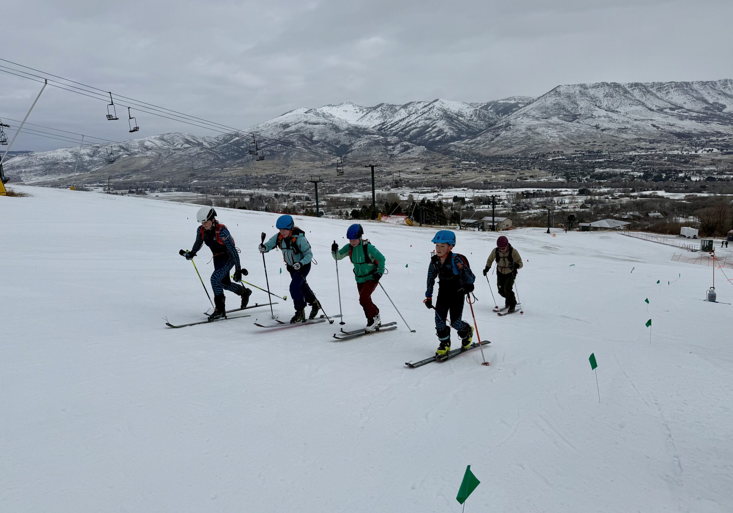 Group of skiers on snowy slope with mountains