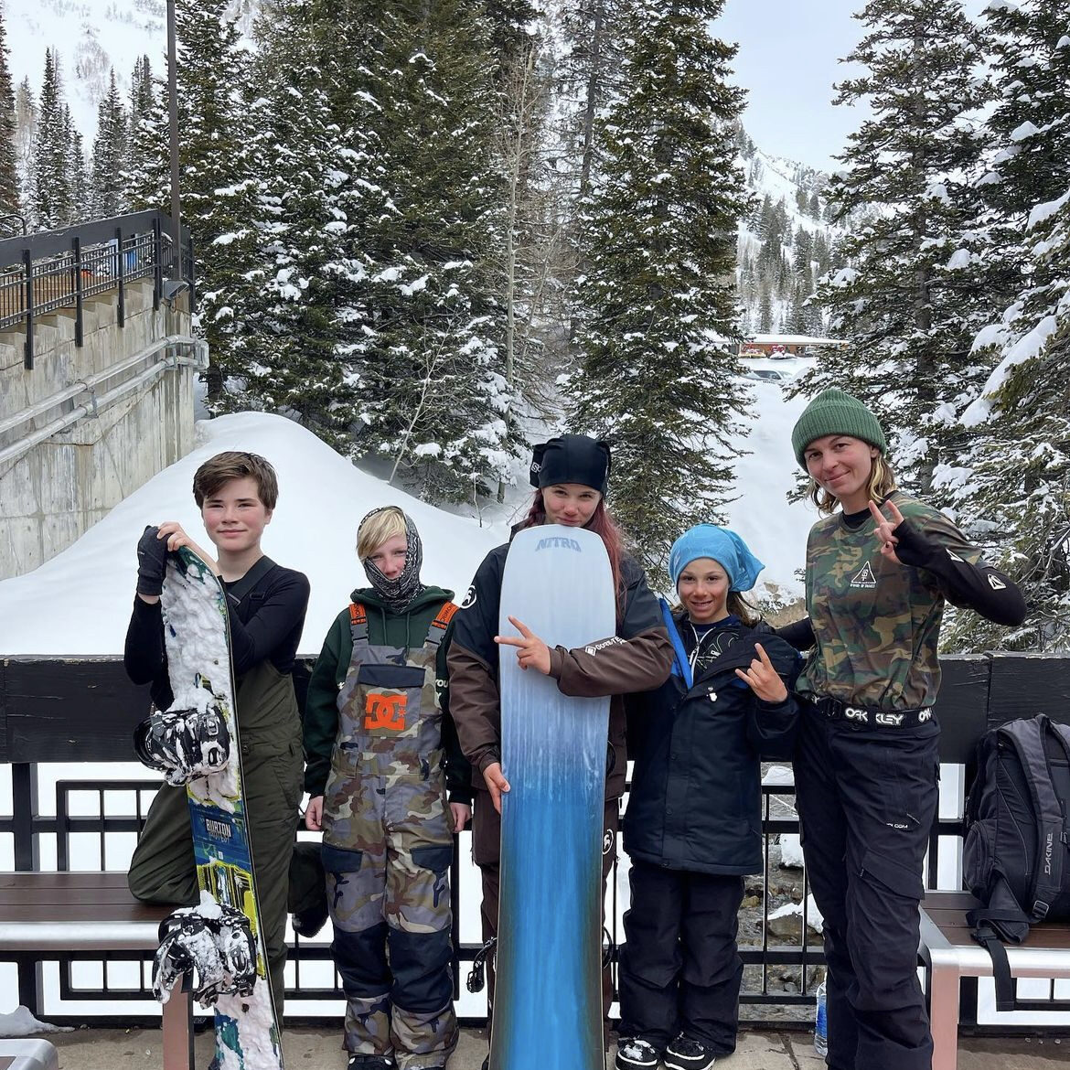 Group of five snowboarders at snowy resort