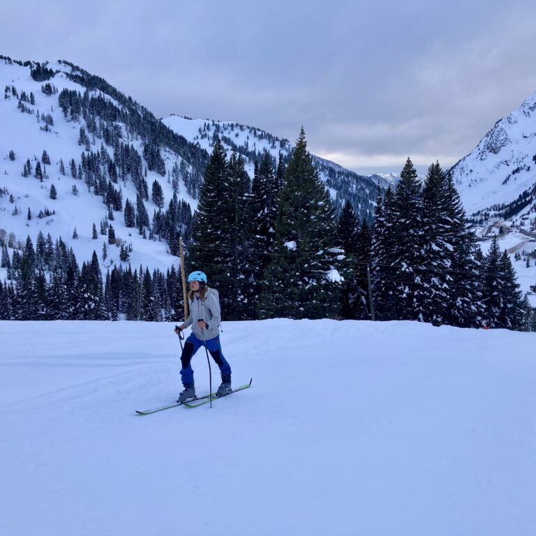 Skier on snowy slope with mountain backdrop